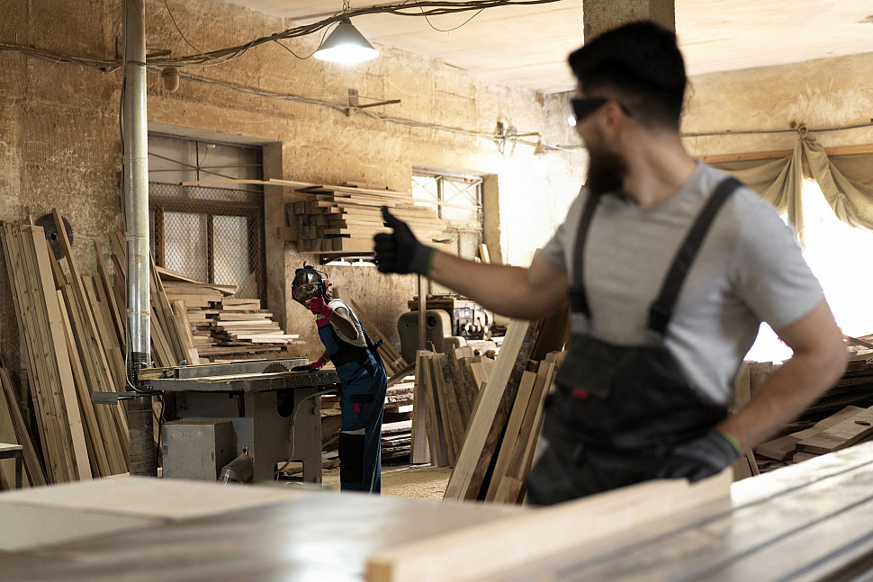carpenter-cutting-mdf-board-inside-workshop
